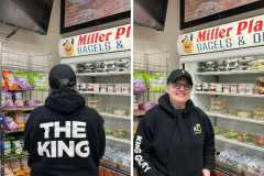 Person in a black hoodie with "THE KING" text, smiling in a store.